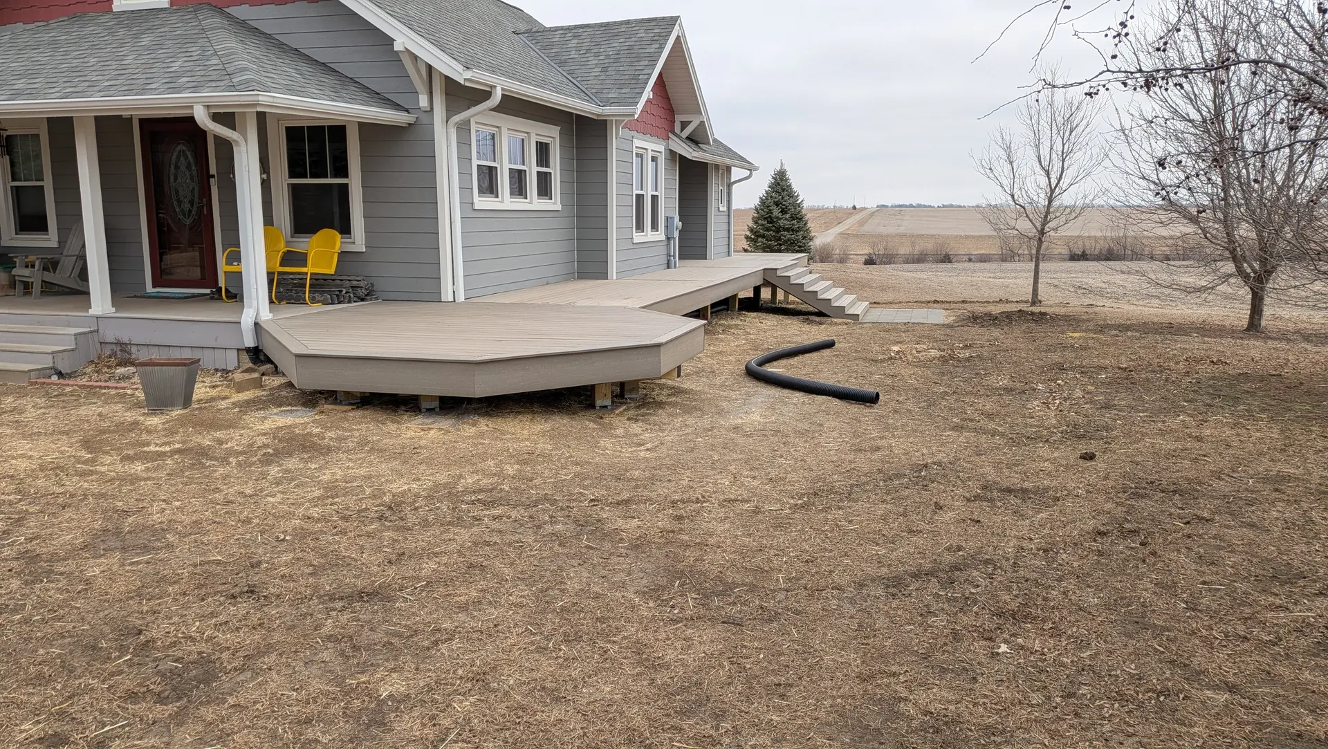 Multi-level composite wraparound deck on a rural acreage home