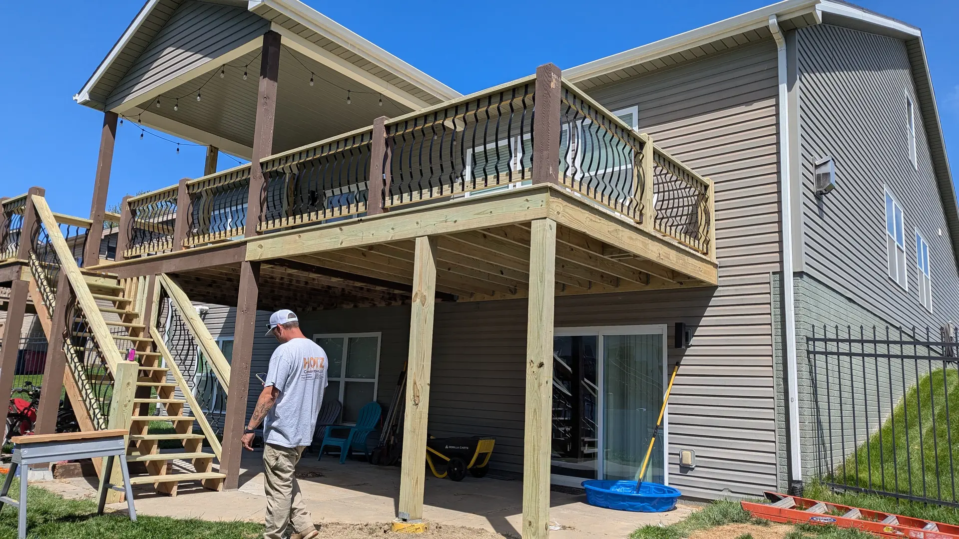 Elevated deck with decorative metal balusters and string lights