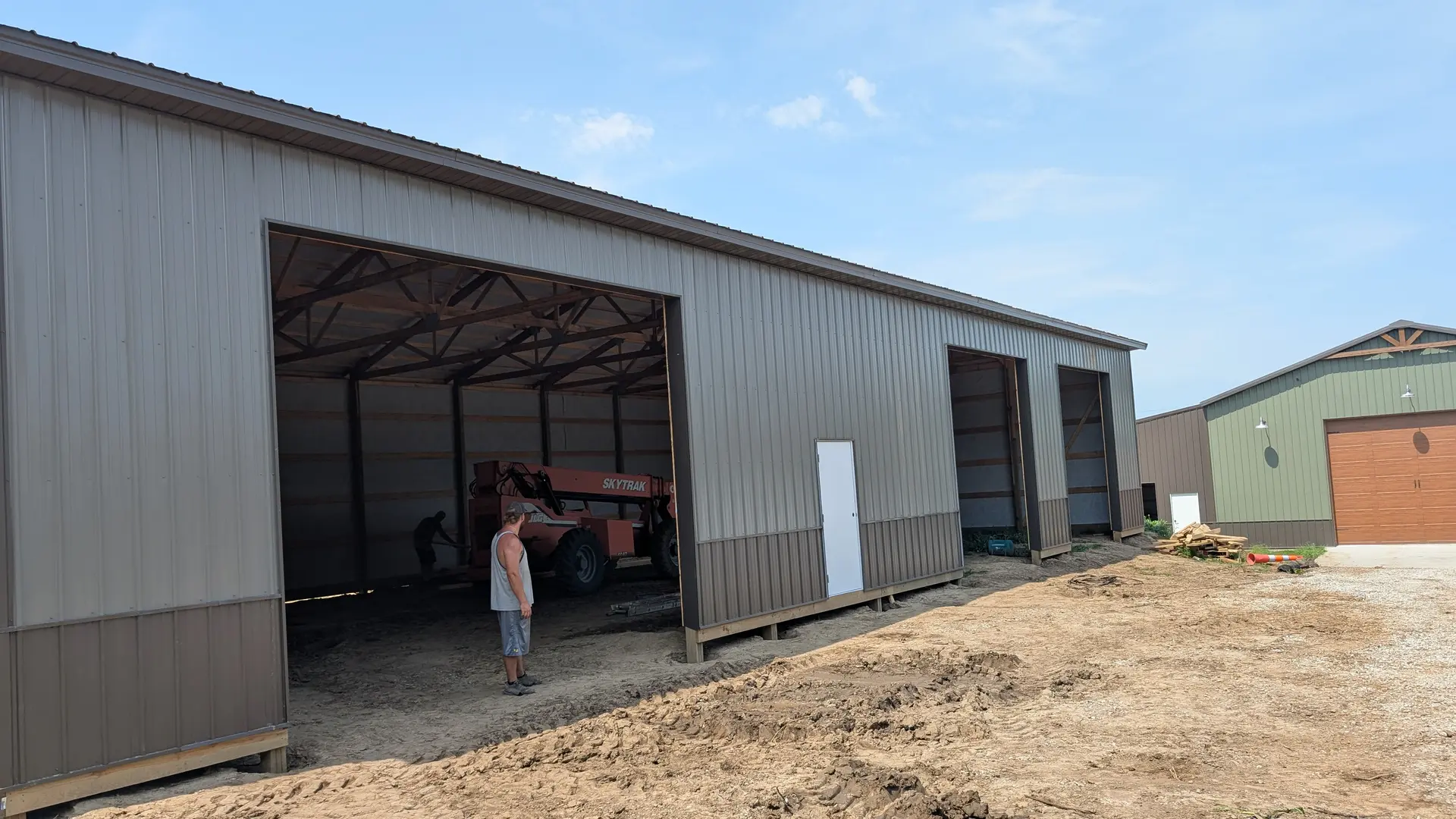 Two-tone steel machine sheds with open equipment bays