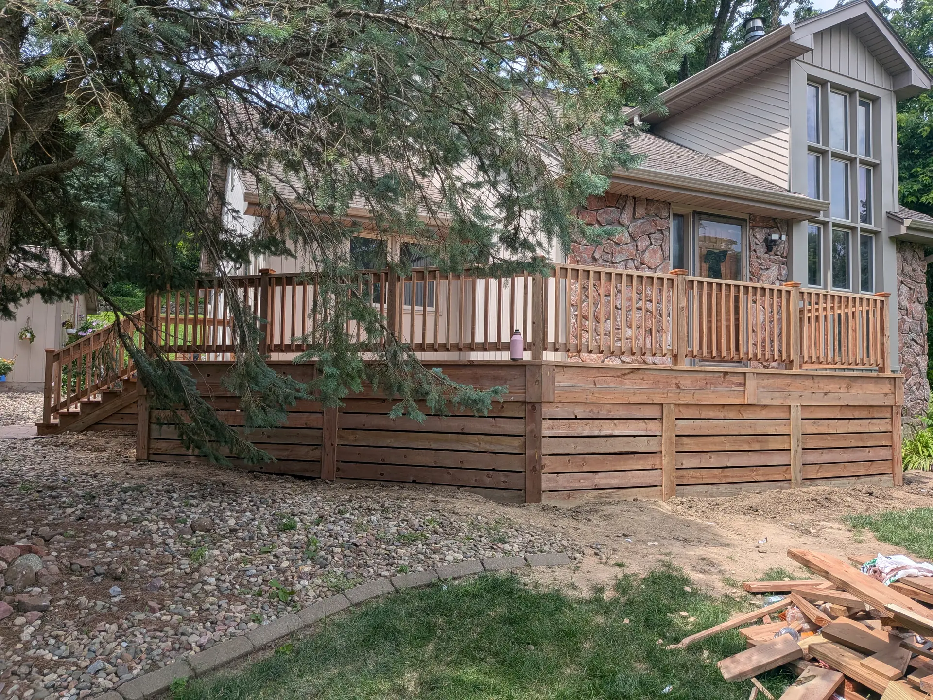 Wraparound wooden deck with horizontal slat skirting
